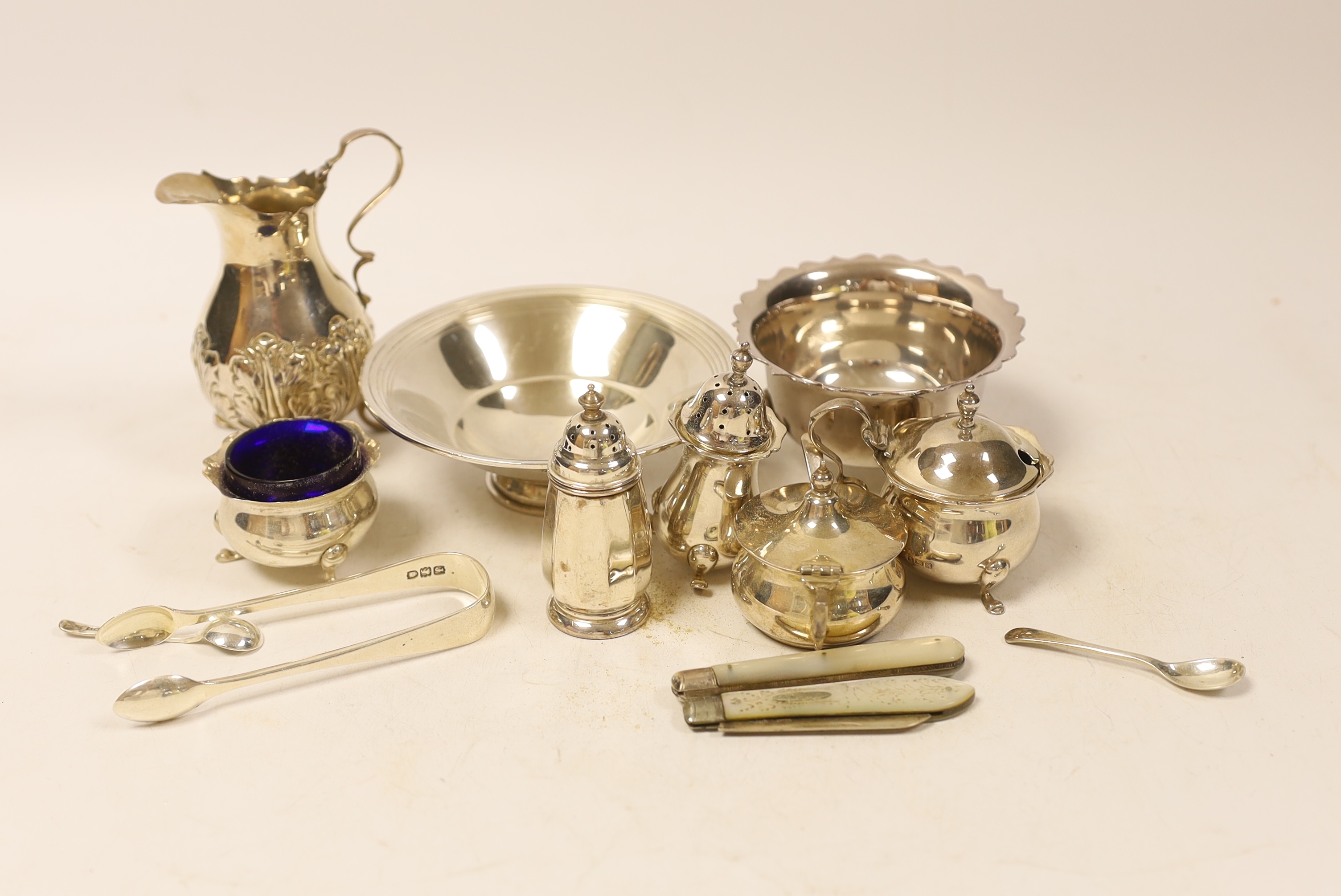 Sundry small silver including two bowls, a late Victorian cream jug, four assorted condiments, two fruit knives and a pair of sugar tongs.